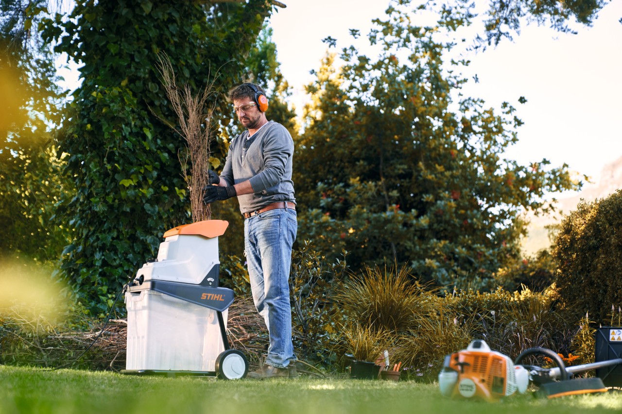 Muž s drtičem STIHL na zahradě